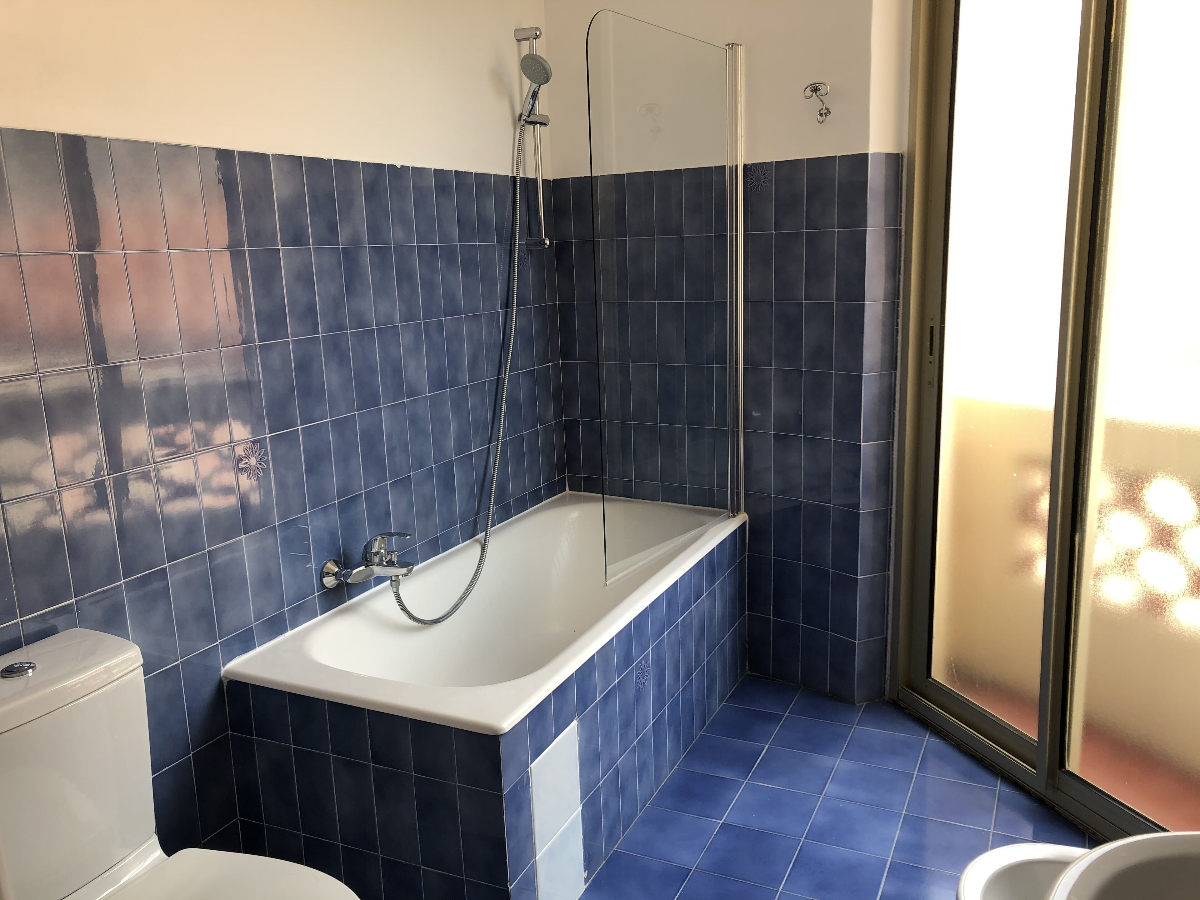 A bathroom with a bathtub, toilet, and shower.