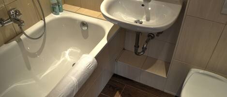 A bathroom with a bathtub, a sink, and a toilet.