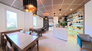 Ein modernes Restaurant mit Bar, Holztischen und -stühlen.
