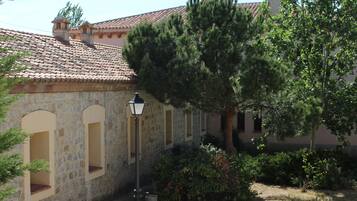 A stone building with arched windows and a tiled roof.
