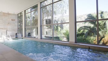 Swim laps in a serene pool surrounded by lush views of the tropical landscape.