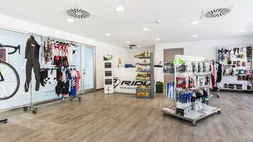 A modern retail store with bicycles, cycling gear, and accessories.