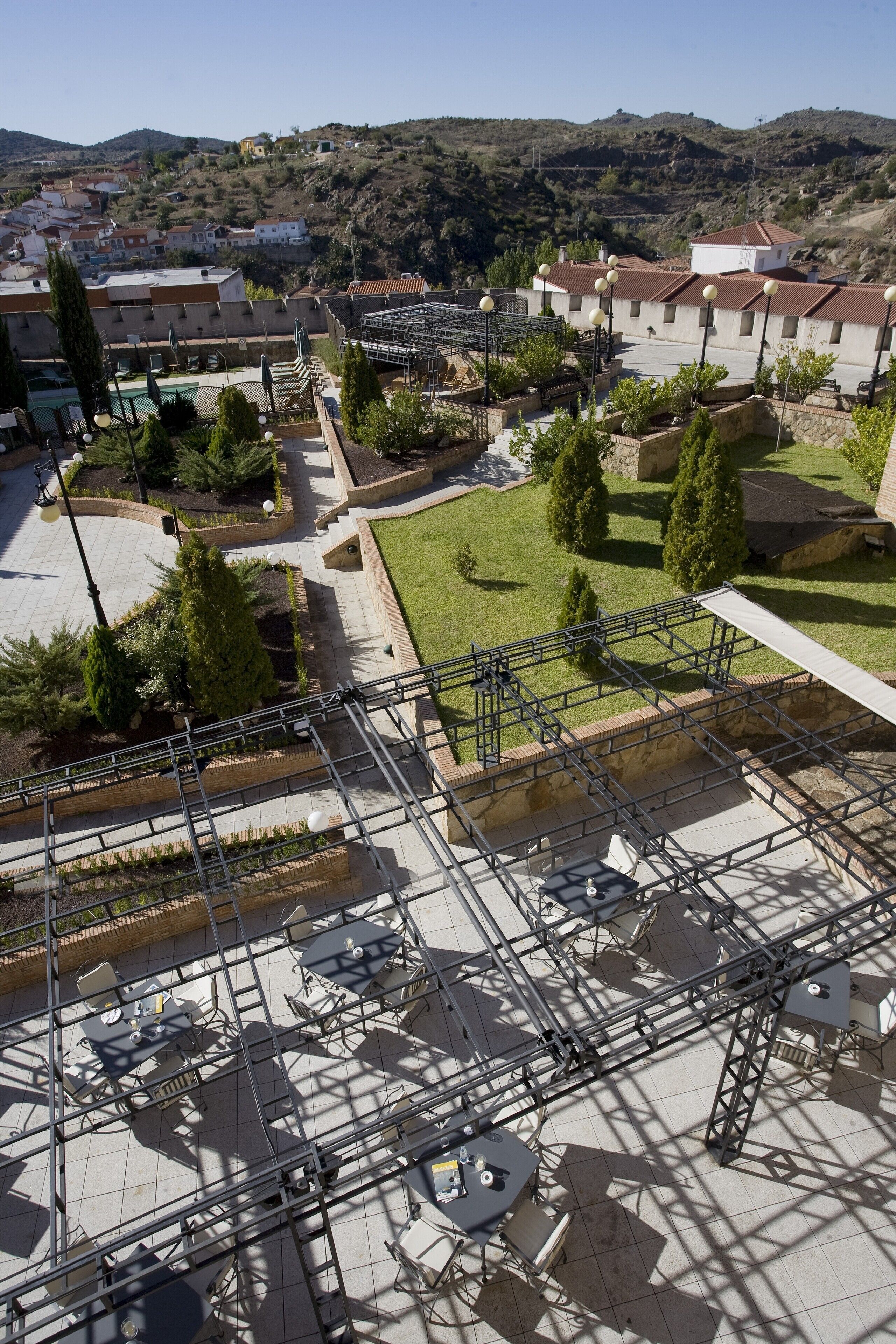 A courtyard with outdoor seating, surrounded by buildings and trees.