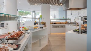 A modern buffet setup with various food items and a clean, contemporary design. - Hotel Planamar by Escampa Hotels (Castell-Platja d'Aro)
