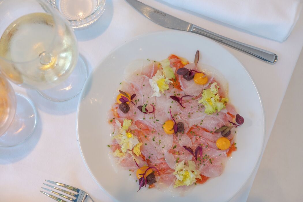 A plate of food with a fork and a knife on a table.