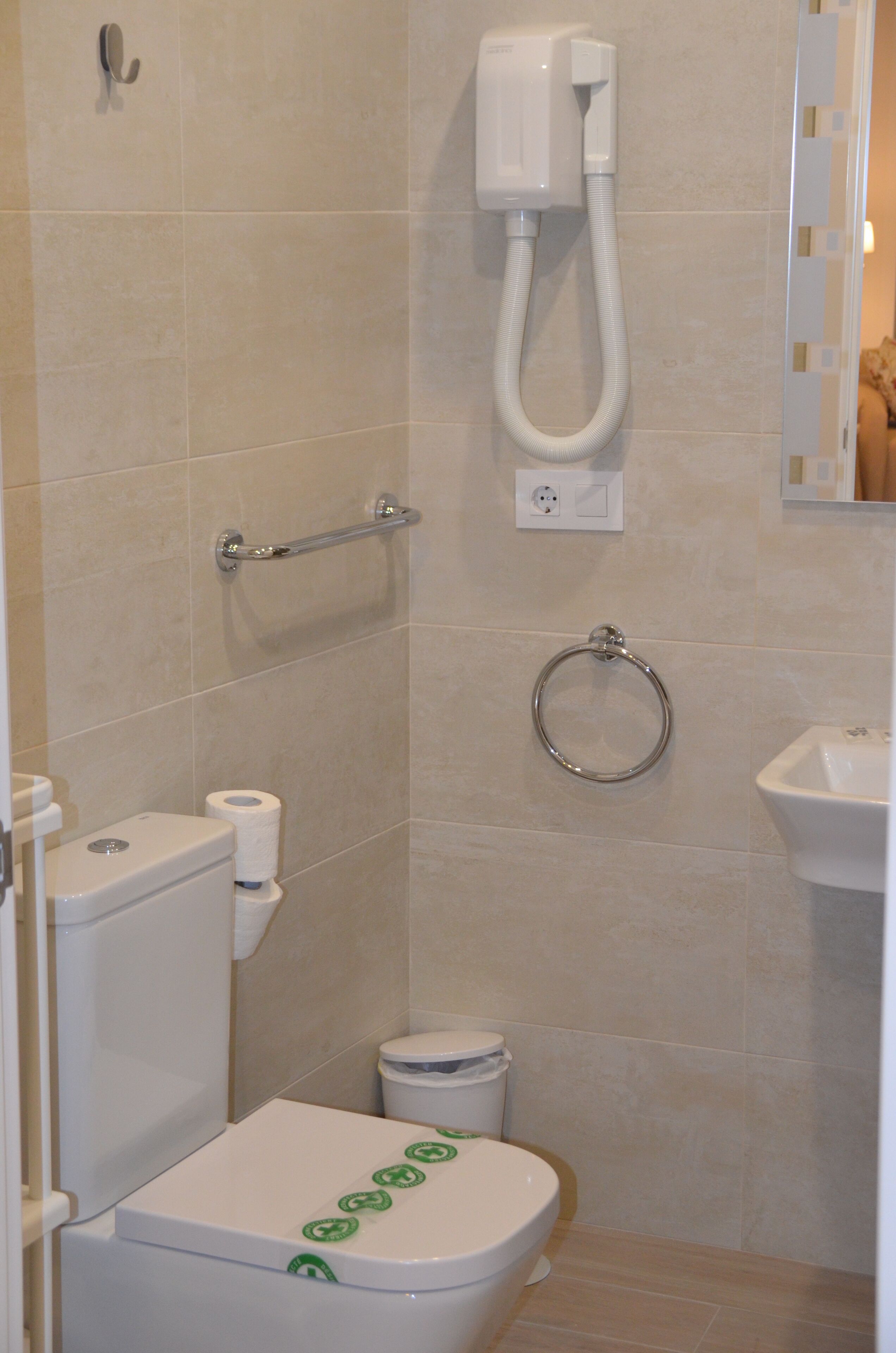 A bathroom with a toilet, bidet, and sink.