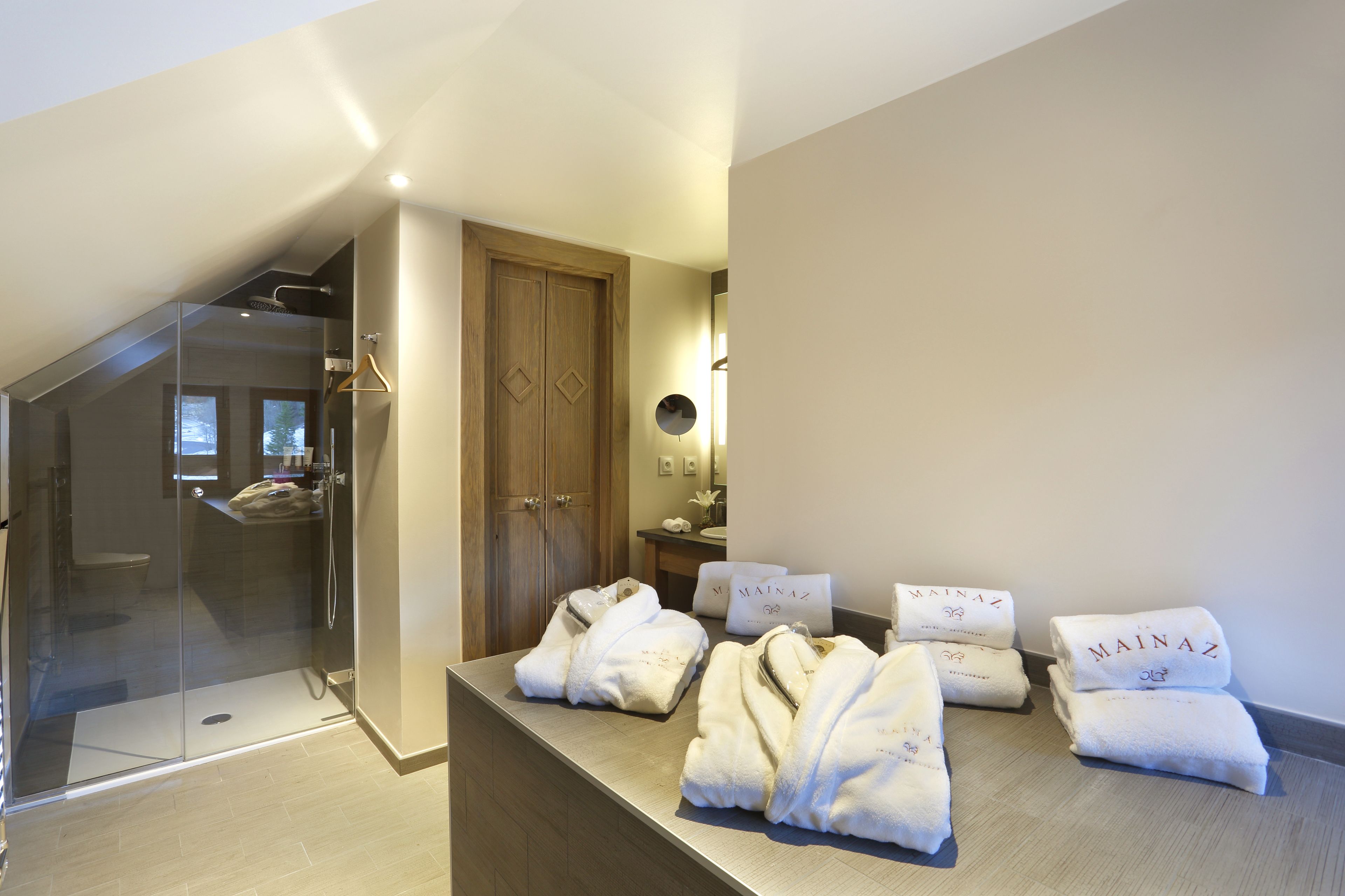 designer toiletries, hair dryer, bathrobes, slippers