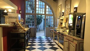 A hotel kitchen with a checkered floor, a coffee machine, and a refrigerator labeled "ANDROS". - Du Musée (Arles)