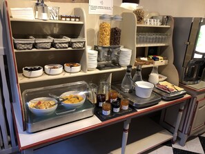 Un bufé de desayuno con diferentes alimentos y acompañamientos.