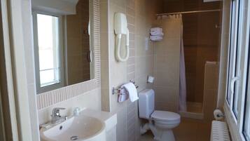A bathroom with a sink, toilet, and shower.