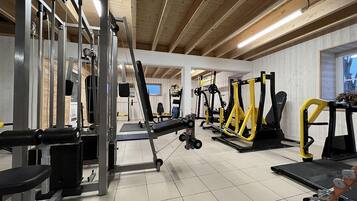 A gym with various exercise equipment, including weight machines and treadmills.