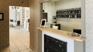A reception area with a mirror, a chalkboard, and a shelf with keycards.