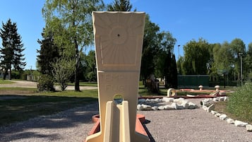 A playground with a slide and a climbing structure.
