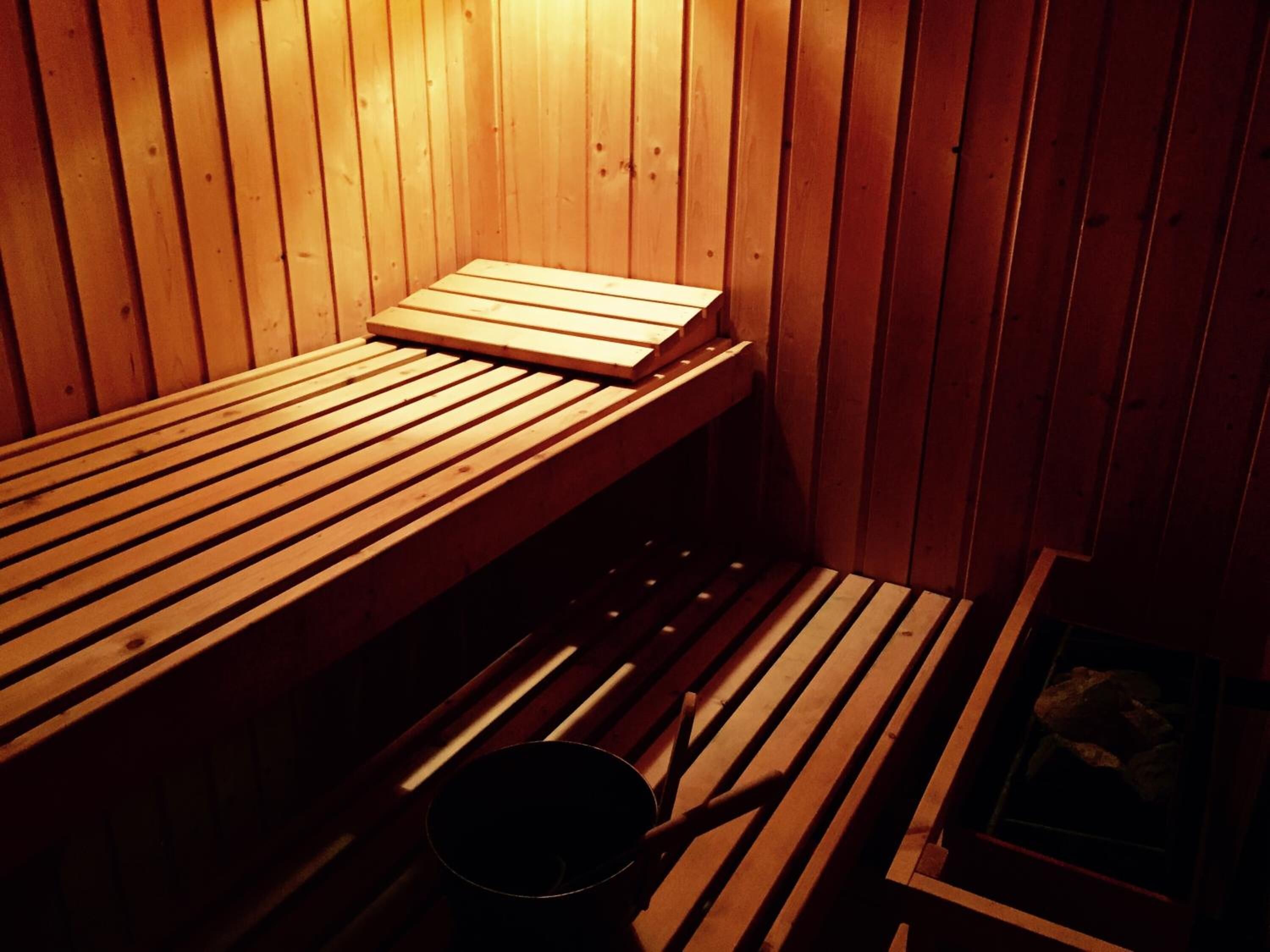 A sauna with wooden benches and a bench seat.