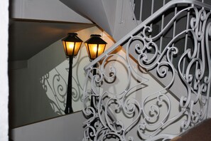 A white wrought iron railing with intricate scrollwork. - Hôtel du Midi (Salon-de-Provence)