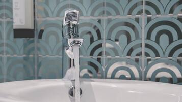 A bathroom sink with a running faucet.