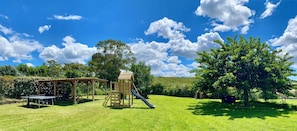 Children can play safely in this outdoor play area featuring a slide and climbing ladder.