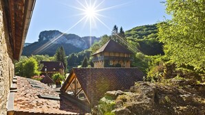 A traditional chalet with a steeply pitched roof, wooden beams, and a stone foundation. - Castel Damandre (Les Planches-pres-Arbois)