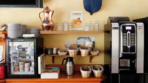 A coffee station with a coffee machine, a kettle, and various coffee cups. - Brit Hotel Le Branhoc (Auray)