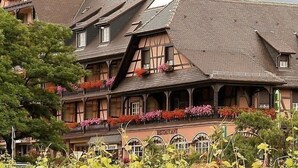 A traditional half-timbered building with multiple balconies and flower boxes.