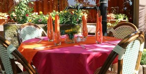 Enjoy dining al fresco in this charming outdoor space with a garden view.