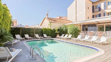 Seasonal outdoor pool, open 8 AM to 9:00 PM, pool umbrellas