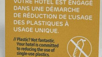 A sign about plastic reduction in a hotel.