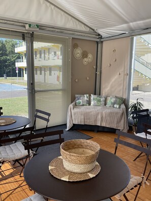 Relax in this inviting space with a comfortable seating area, round table, and plush bed.