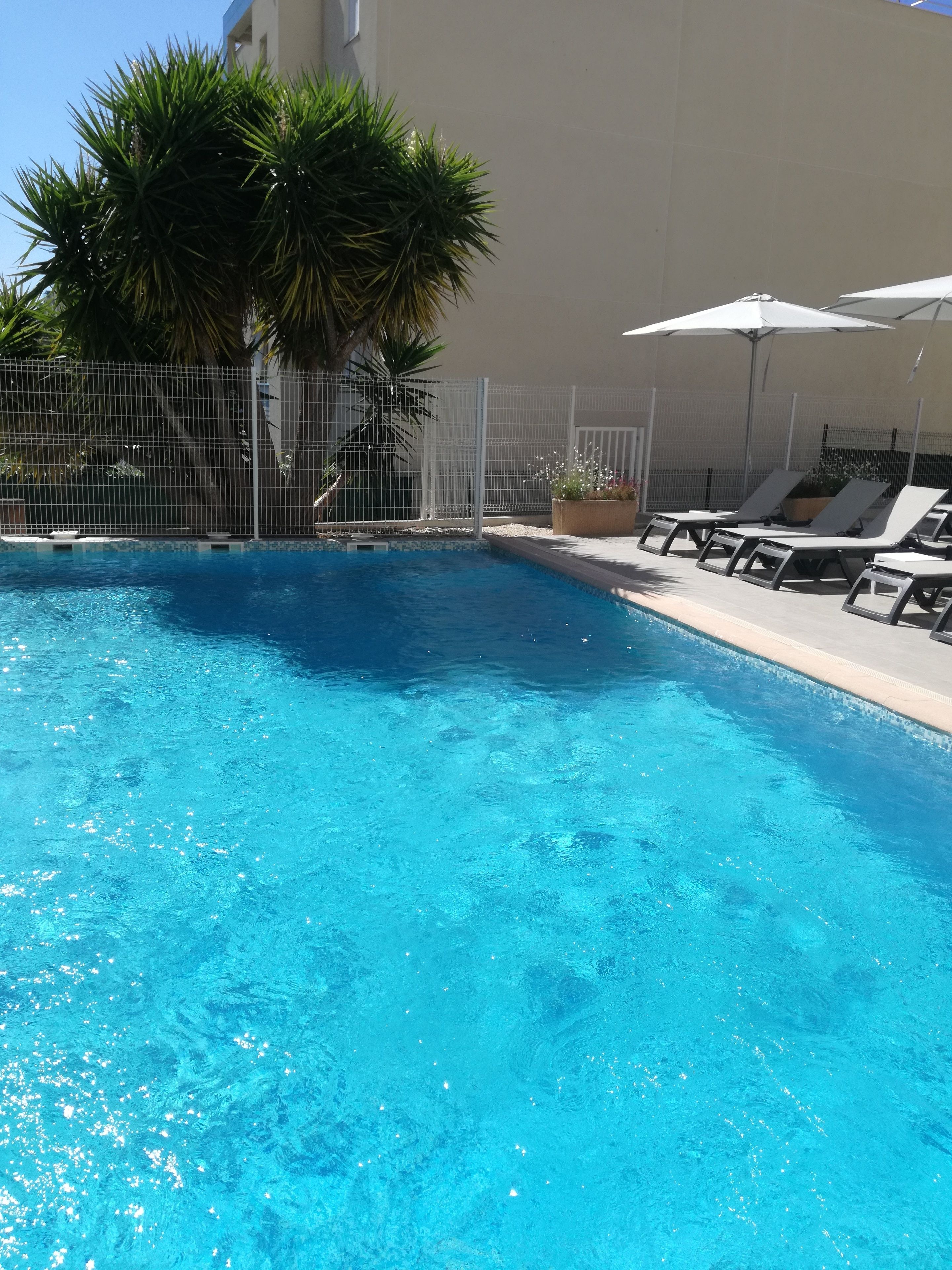 Seasonal outdoor pool, open 9:00 AM to 8:00 PM, pool umbrellas