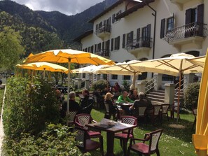 An outdoor dining area with yellow umbrellas, tables, and chairs.