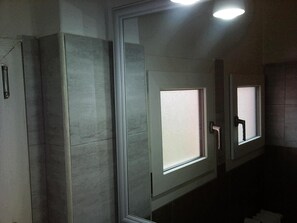A bathroom with three doors, each with a frosted glass window and a door handle. - Hotel Bristol (Sesto San Giovanni)