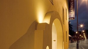 A building facade with a large archway and a sign for 'Albatros Hotel'. - Hotel Albatros Varigotti (Finale Ligure)