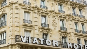 A building with ornate architectural details and a sign that reads "VIATOR HOTEL".