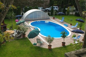 Seasonal outdoor pool, open 8:00 AM to 10:00 PM, pool umbrellas