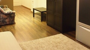 A modern room with a large wardrobe, a small table, and a sofa. - Budapest Royal Suites II (Budapest)