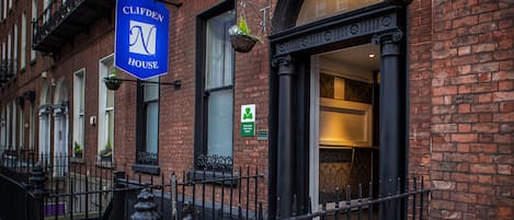 A brick building with a sign reading "Clifden House."