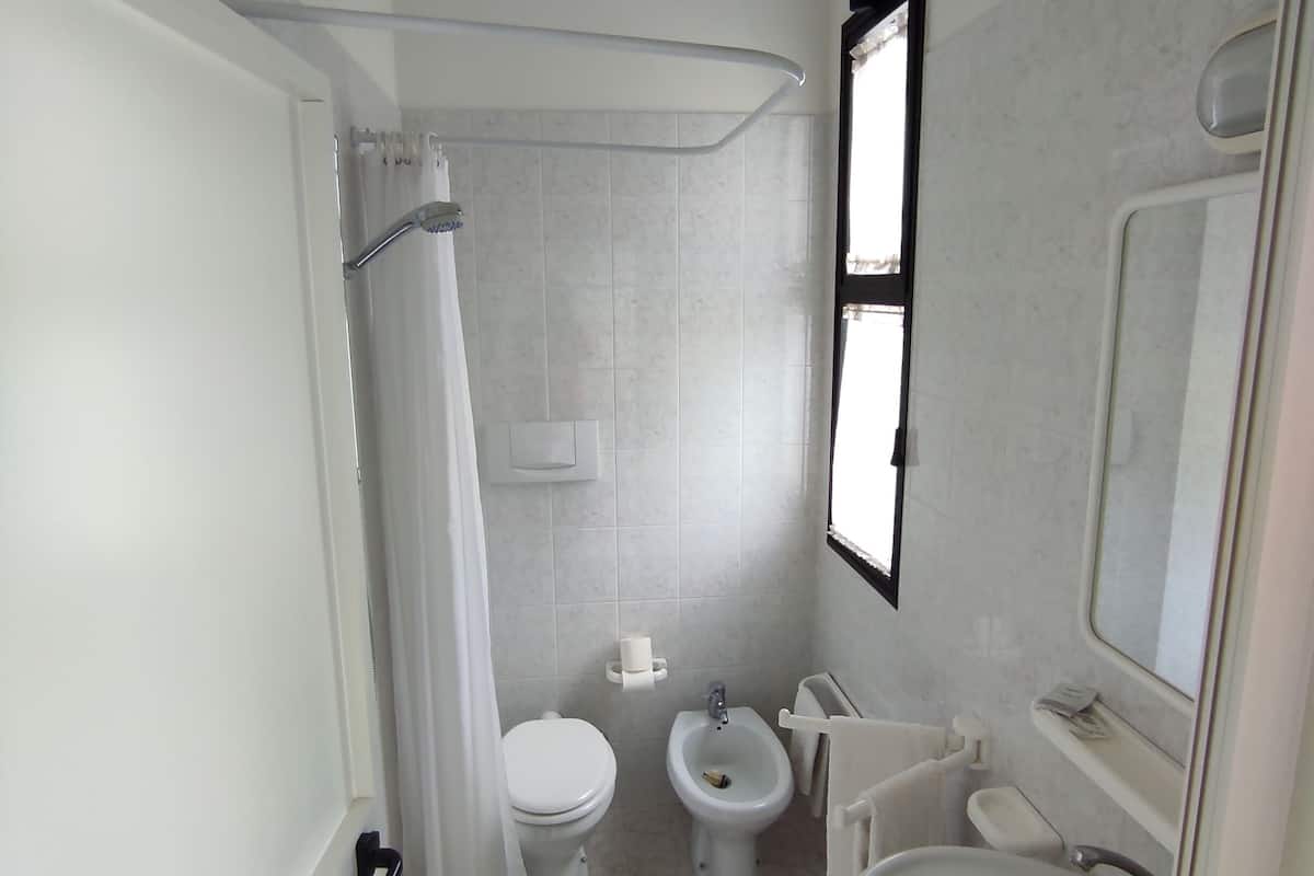 economy single room | bathroom | shower, free toiletries, hair dryer, dressing gowns