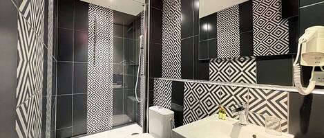 A modern bathroom with a shower, toilet, and sink.