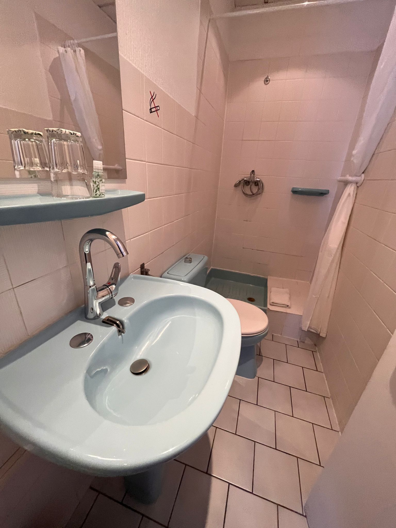 A bathroom with a sink, toilet, and shower.