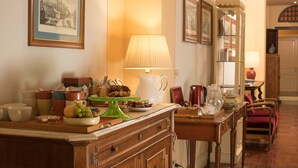 A dining area with a table set for a meal, a lamp, and a mirror. - Residenza Johanna I (Florence)
