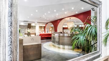 Welcome to our hotel lobby, featuring a central reception desk and comfortable seating area.
