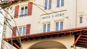 A building with a sign reading "HOTEL S'JULIEN" and a car parked in front. - Hôtel St-Julien (Biarritz)