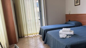 A hotel room with two beds, a wooden headboard, a window with sheer curtains, and a tiled floor. - Hotel Salerno (Milan)