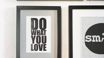 A wall with multiple framed quotes and a framed text saying "DO WHAT YOU LOVE".