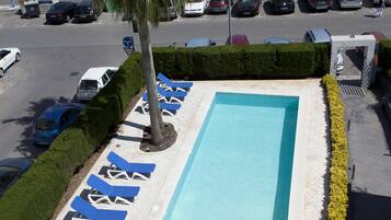 Seasonal outdoor pool, open 10:00 AM to 10:00 PM, pool loungers