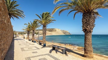 Beach nearby, white sand, beach towels
