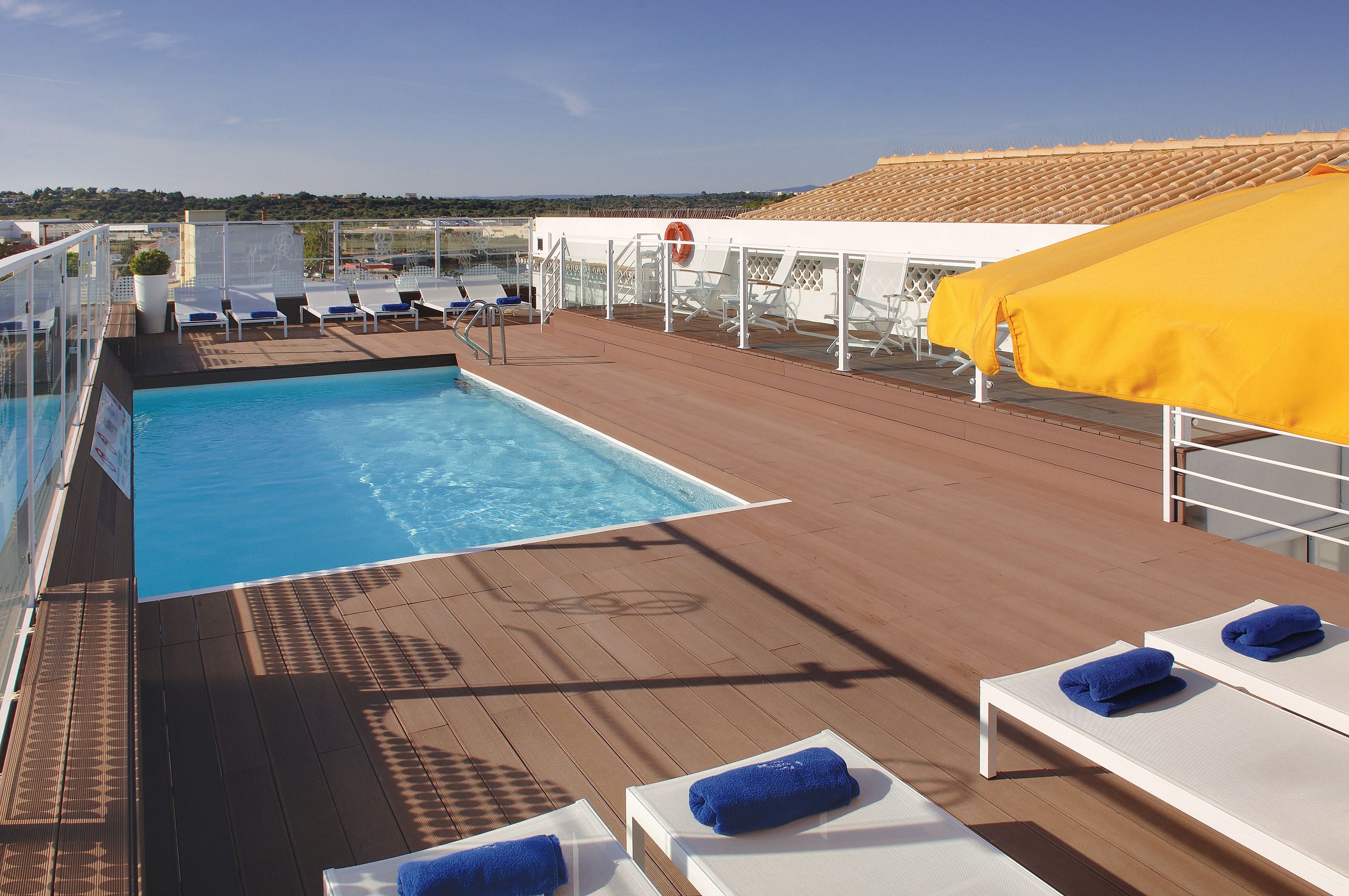 outdoor pool, open 8:00 am to 8:00 pm, pool umbrellas, pool loungers