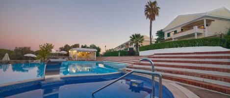 A swimming pool with steps leading up to a building.