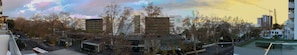 A modern building with a glass facade, surrounded by trees and other buildings. - Paraíso - Touristic Apartments (Funchal)