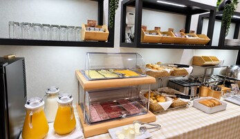 A buffet setup with various food items and beverages.